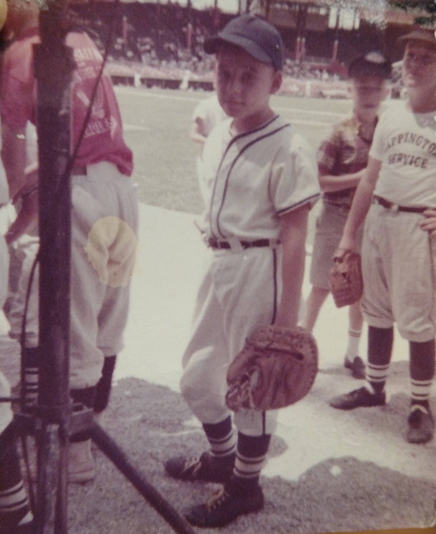 A young baseball player posing on the field