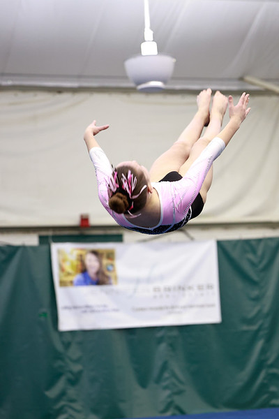 A girl doing a backflip in the air