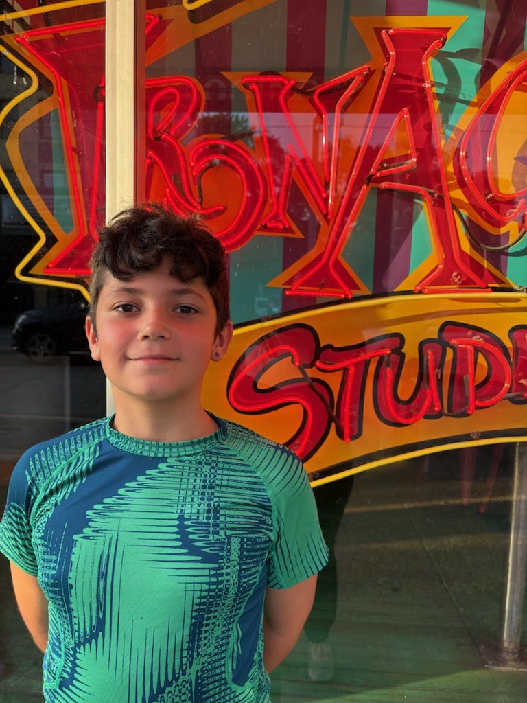 A grandson standing in front of a neon sign