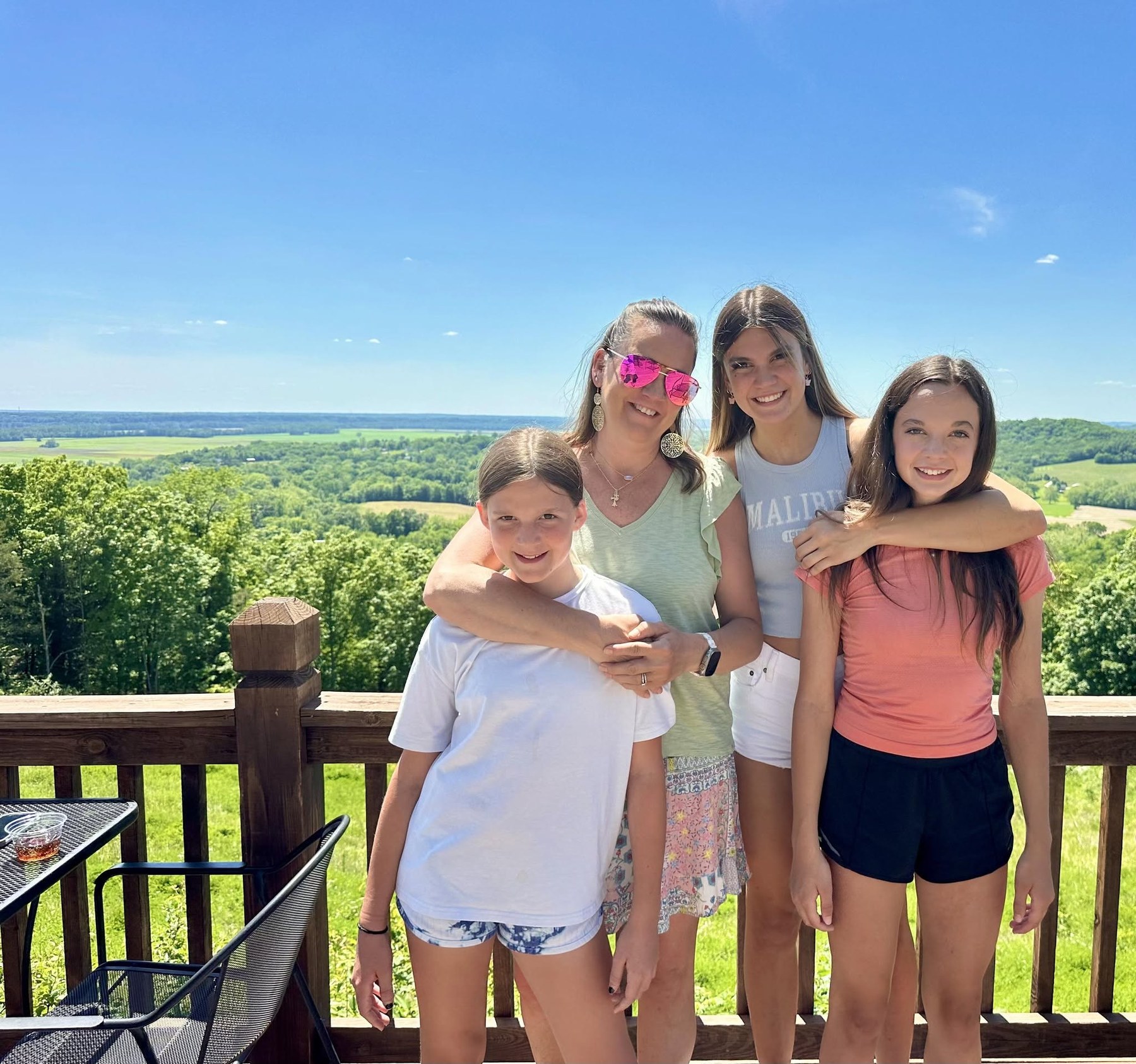 Family members smiling together at a scenic overlook