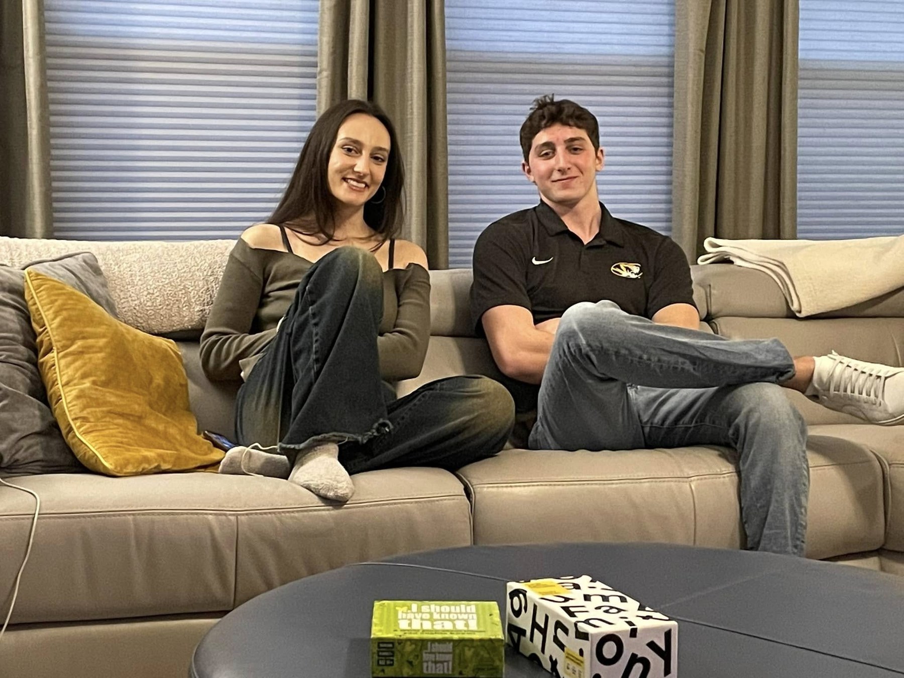 Two grandchildren seated together on a couch