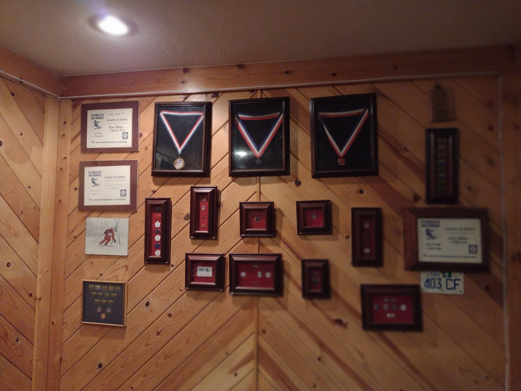 Close view of framed skiing medals and awards
