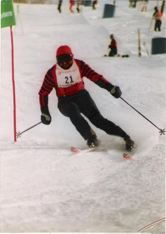 Vince skiing through a slalom gate in race bib 21