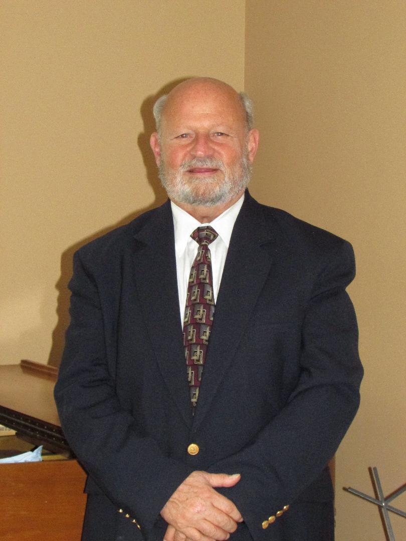 Vince wearing a dark suit and patterned tie